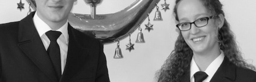 Sören Wehn (links) übergibt den Taktstock an die neue Dirigentin der Jungen Harmonie Emi Bosch (rechts).